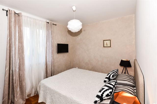 Double bedroom with curtained window