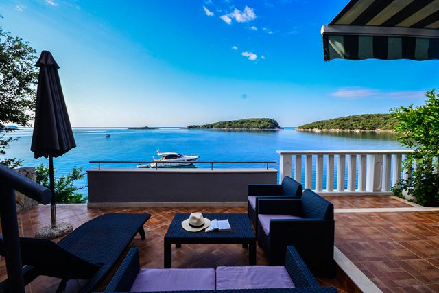 Shaded terrace with seating above the bay