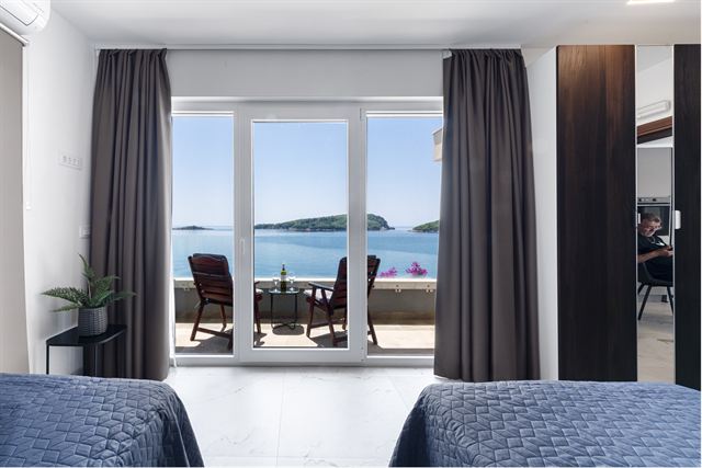 Twin bedroom opening onto a sea-view terrace